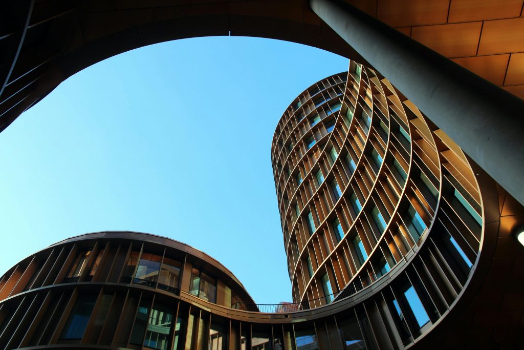 pexels-photo-417273-417273 Innovative modern architecture showcasing curved glass structures against a clear blue sky.